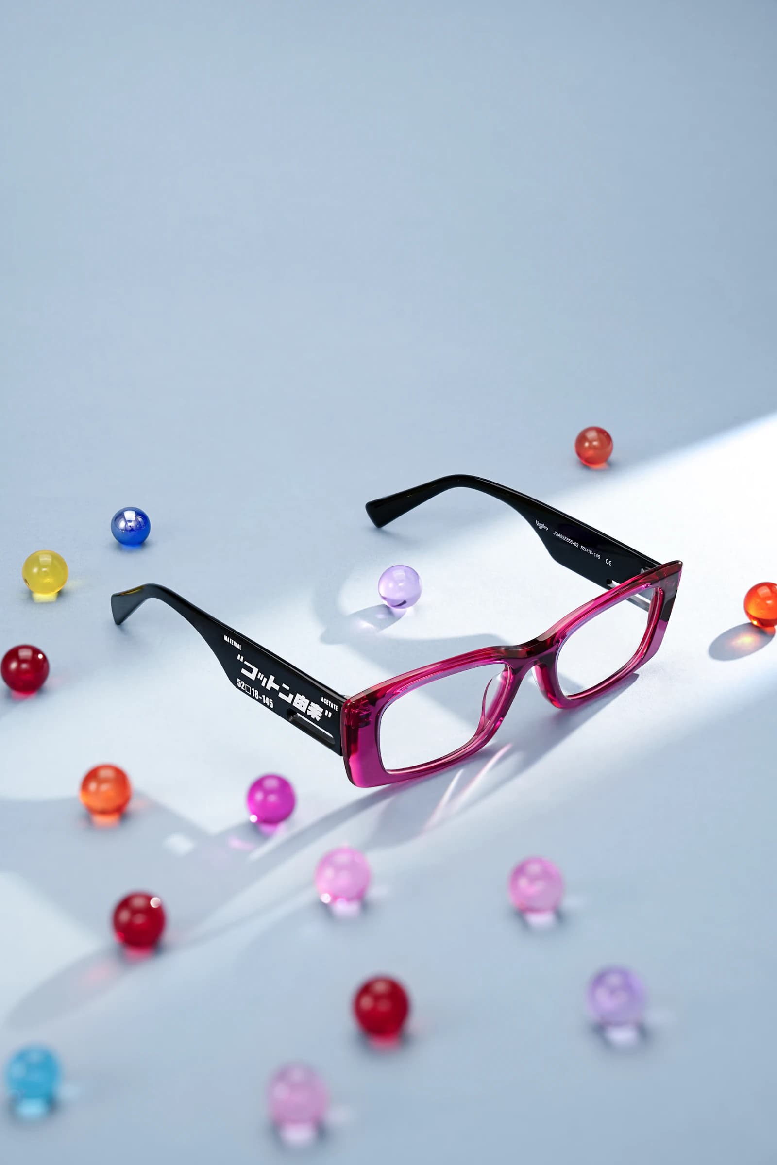 Sculptural colorful acetate eyewear in the spirit of Anne et Valentin Toulouse color theory on a natural surface