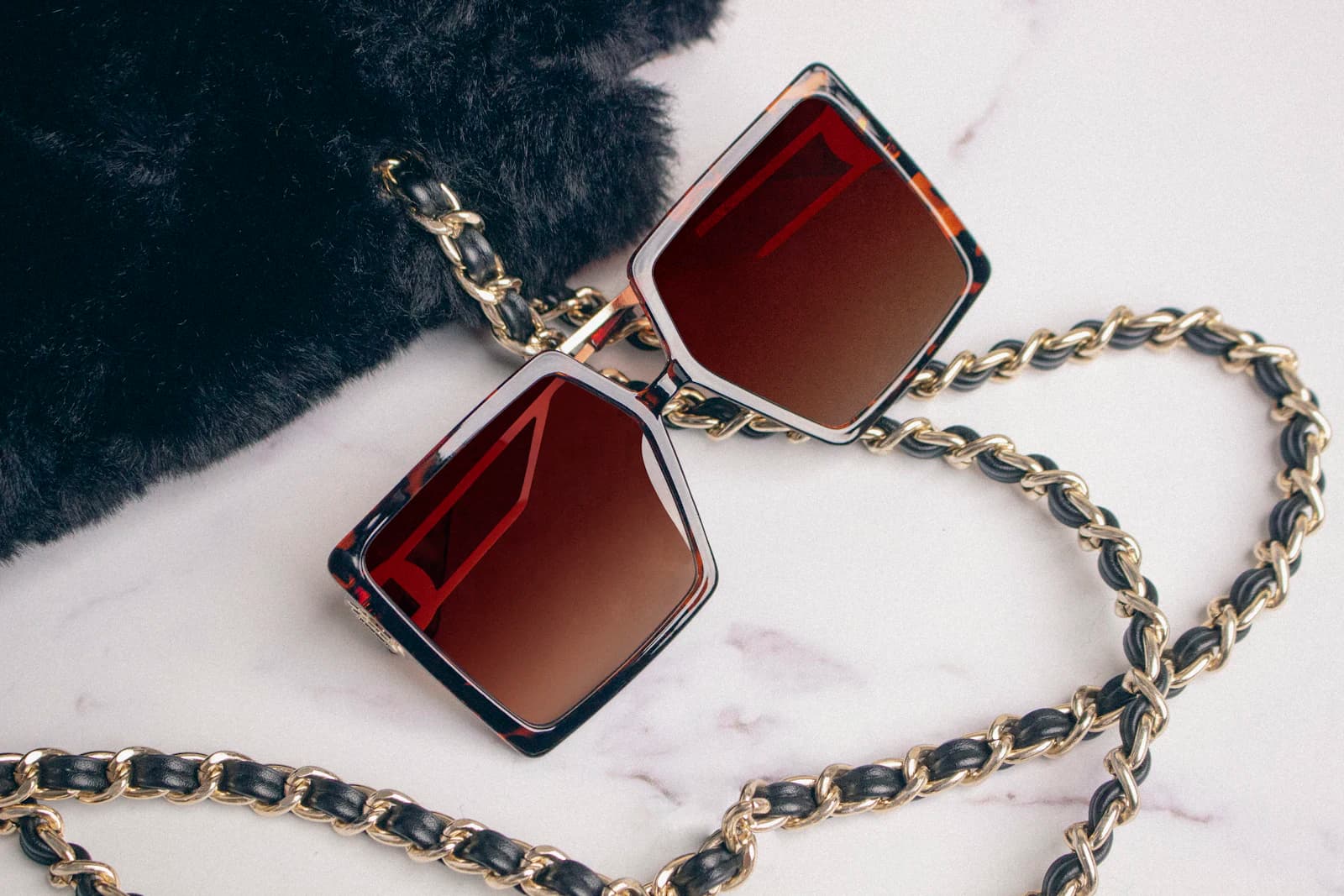 Chunky black eyewear with bold metal hardware evoking Chrome Hearts sterling silver Los Angeles design
