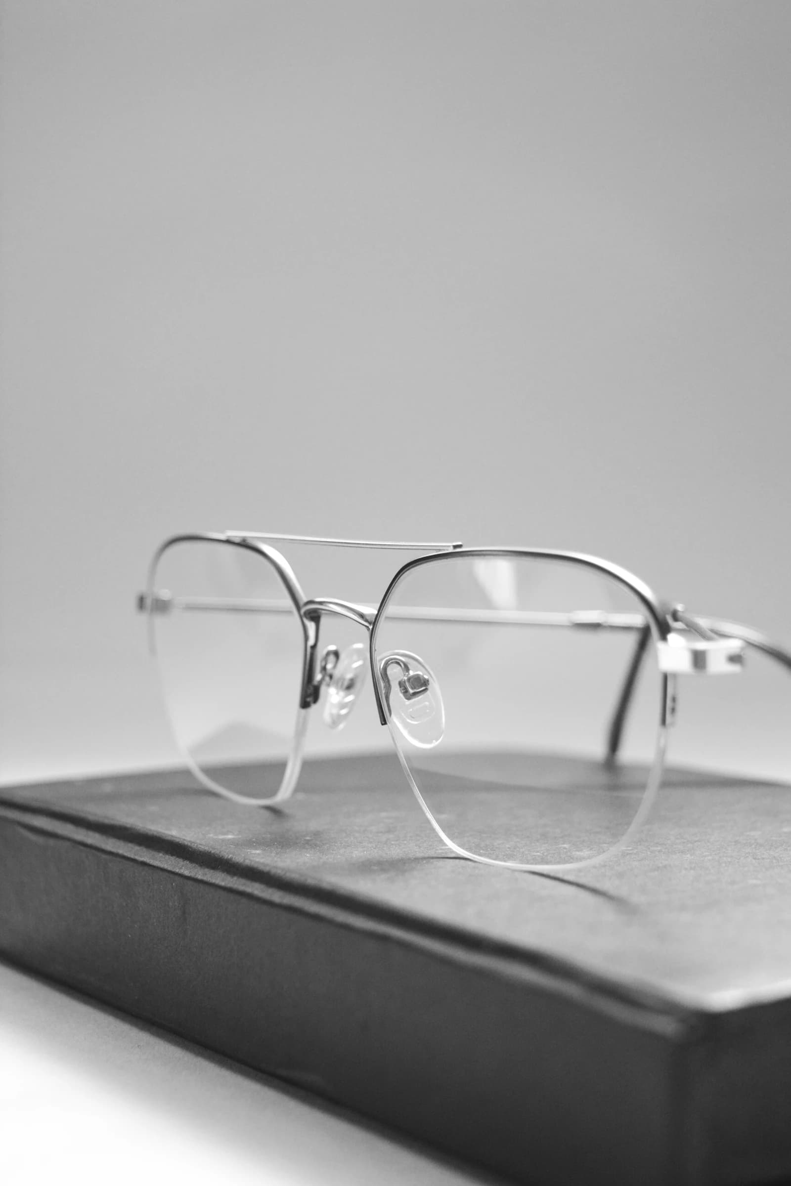 Minimalist titanium rimless eyewear in the spirit of Lindberg's Danish design benchmark on a clean neutral surface